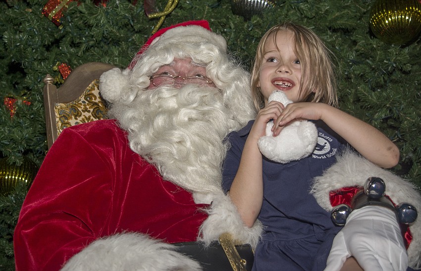 Caitlin Cail poses with Santa during the Sarasota downtown tree lighting celebration