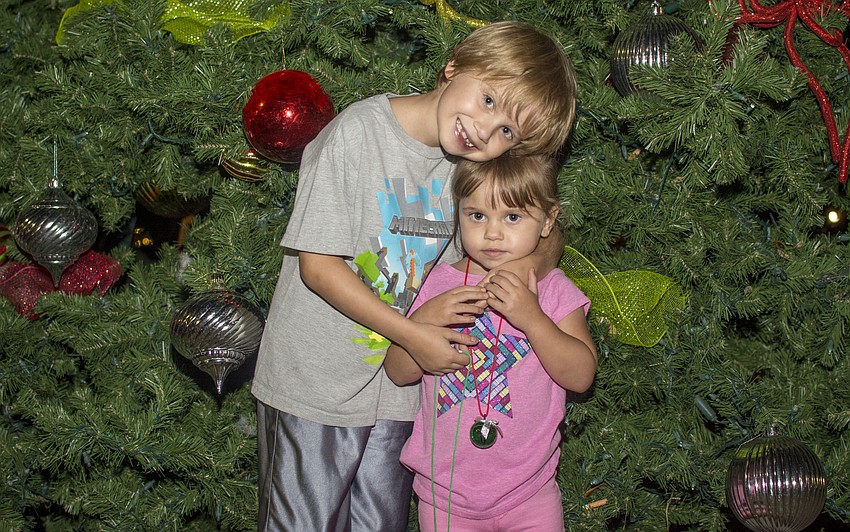 Jack and Allie Hilton pose in front of the tree in Five Points Park.
