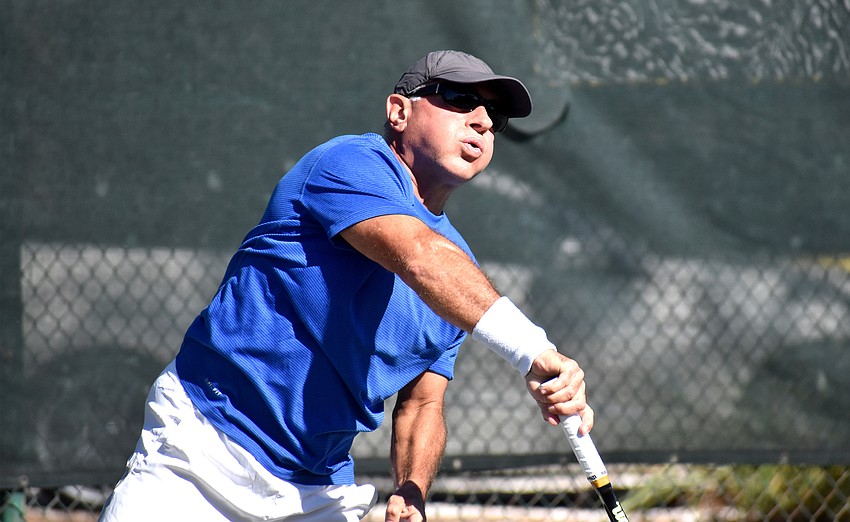 Alexander Pier serves during the Senior Clay Courts Super Category II Tournament.