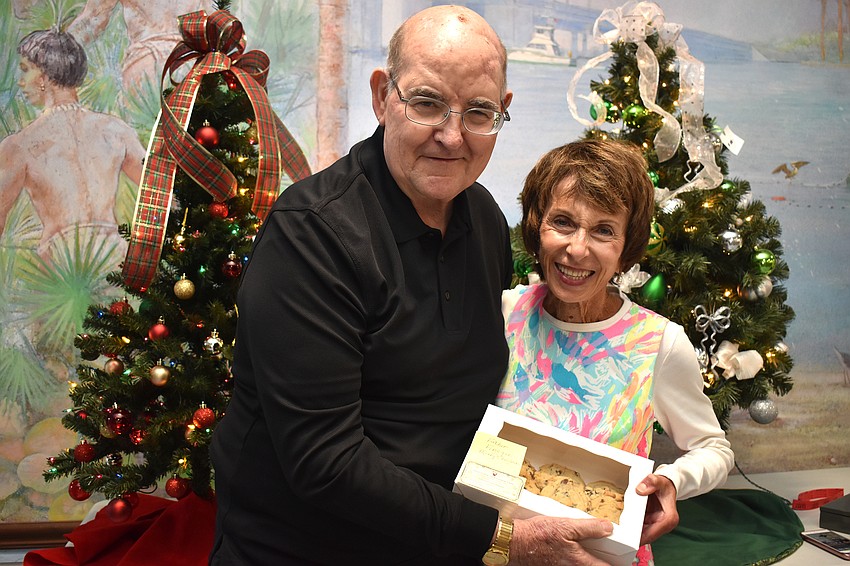 Monsignor Gerry Finegan and Maryann Mazzaferro with the cookies she made for him.