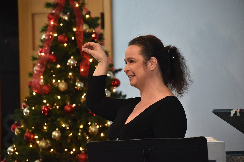 Opera singer Michelle Giglio performs while the crowd sings along.