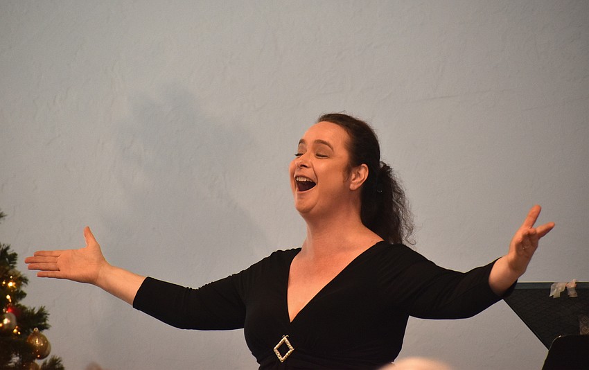 Opera singer Michelle Giglio performs while the crowd sings along.