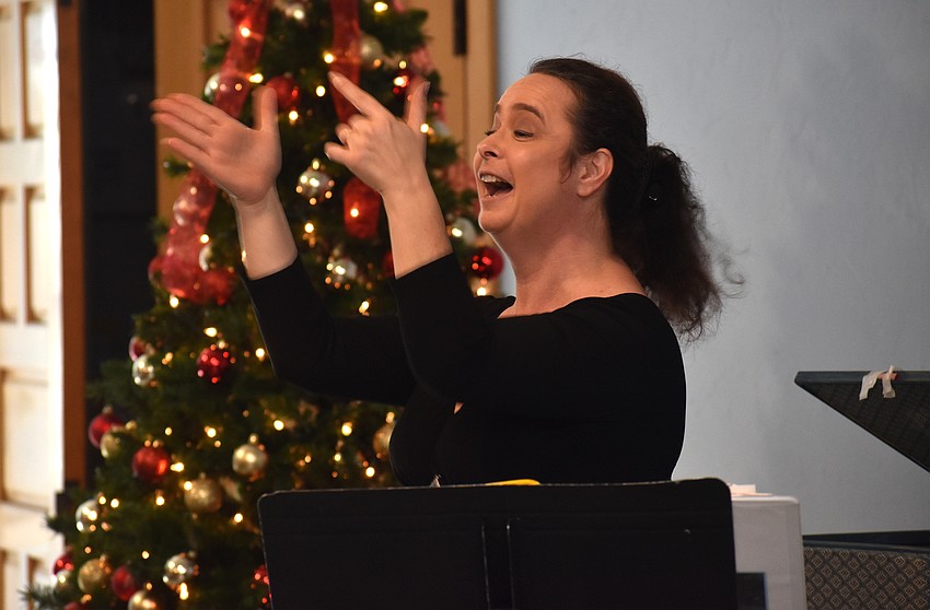 Opera singer Michelle Giglio performs while the crowd sings along.