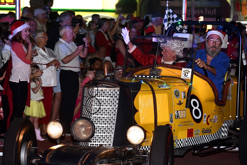 Mrs. Claus waves to the crowd as she arrives at St. Armands Circle.