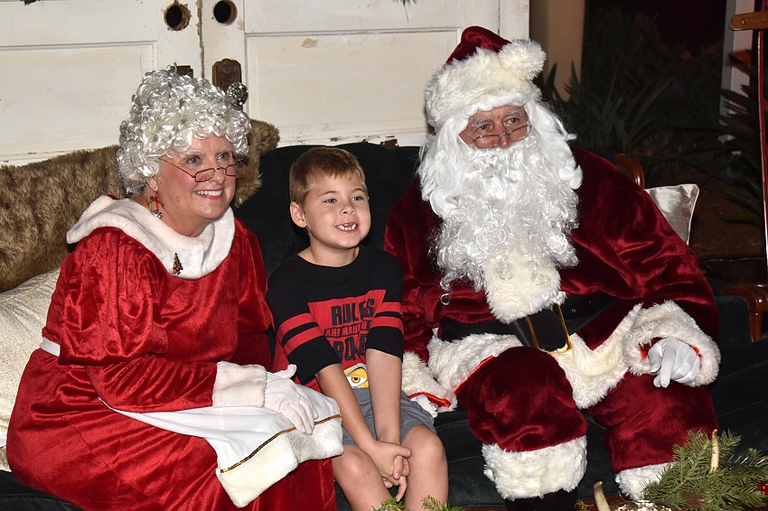 Chase Marud smiles with Santa and Mrs. Claus.
