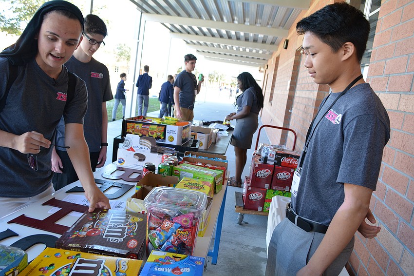 Braden River's Zac Phillips, front left, pretends to be a TSA mom shopping for snacks from Alex Touch, right, for a video competition in which students had about three hours to shoot and create a 60-second video.