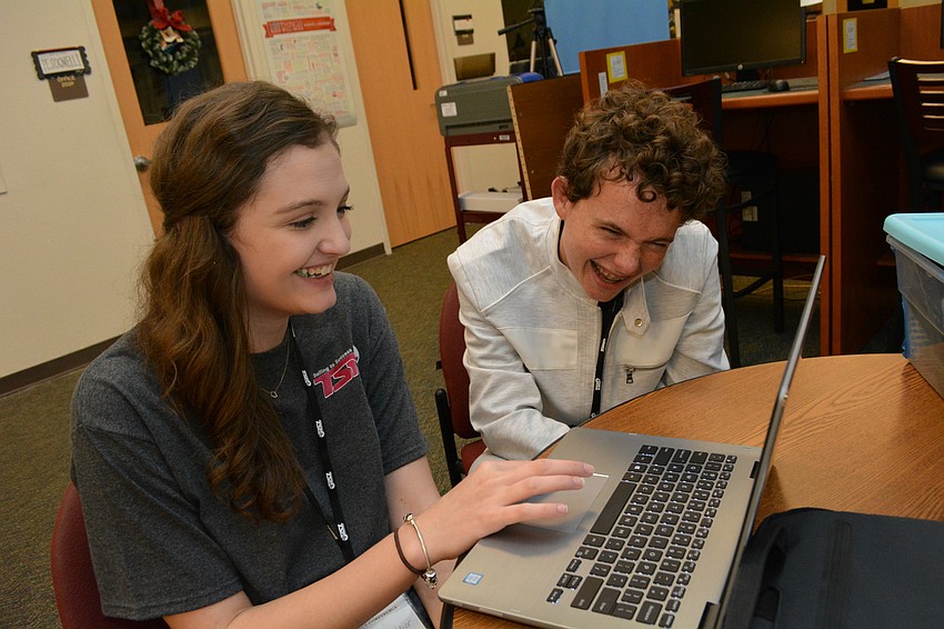 Palmetto High School's Macy Kendzior gets encouragement from friend Stefano Visentin as she prepares to do a presentation on the energy crisis.