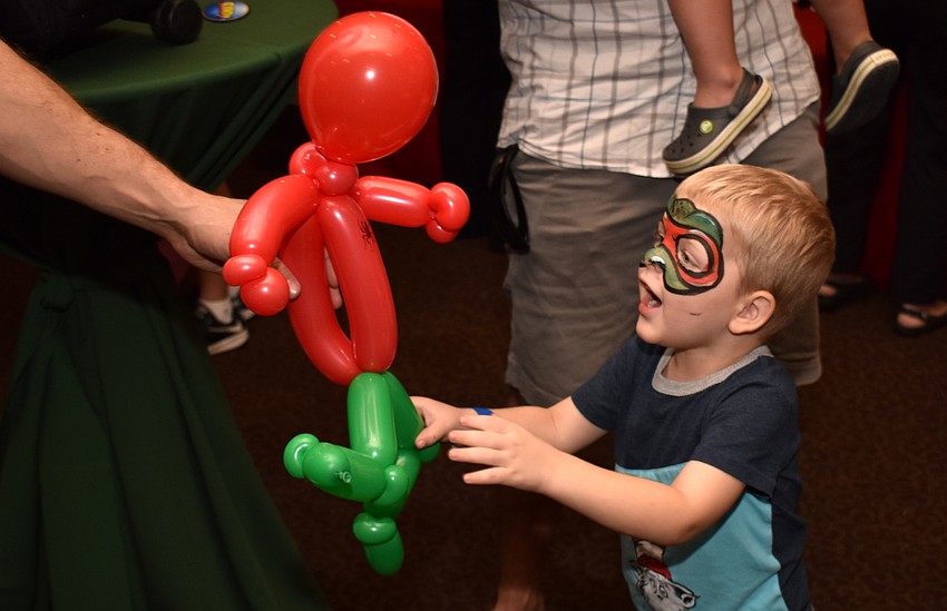 Christopher Battick is all smiles as he gets his Spiderman balloon.