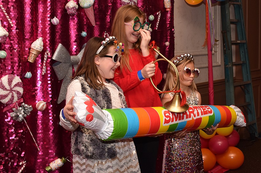 Sadie and Lila Rowley and Ella Otchet pose in the photo booth.