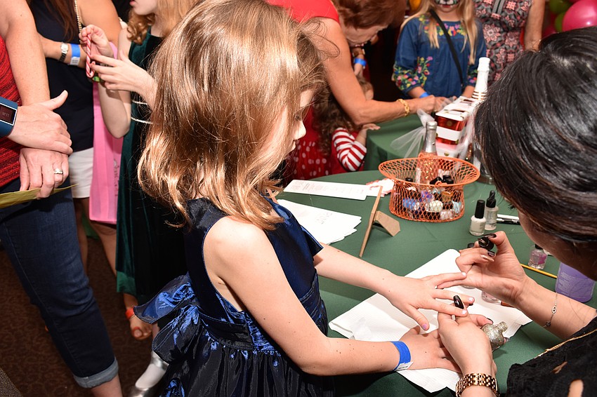 Daphne Quintal gets her nails painted.