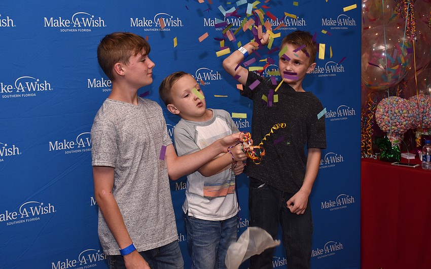 Jake, Cole and Bleu Bielen enjoy the pop-a-balloon photo booth.
