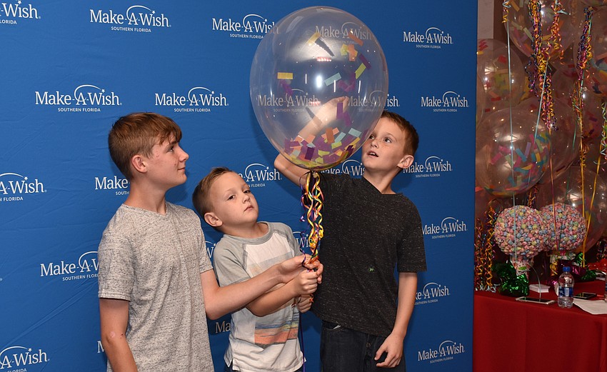 Jake, Cole and Bleu Bielen enjoy the pop-a-balloon photo booth.