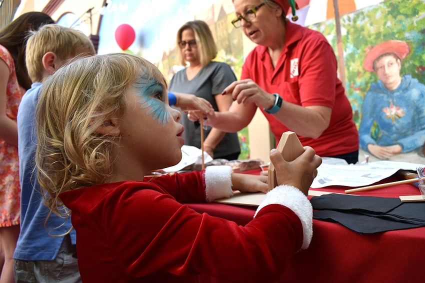 Charlie Marinucci listens to instructions on how to build a birdhouse.