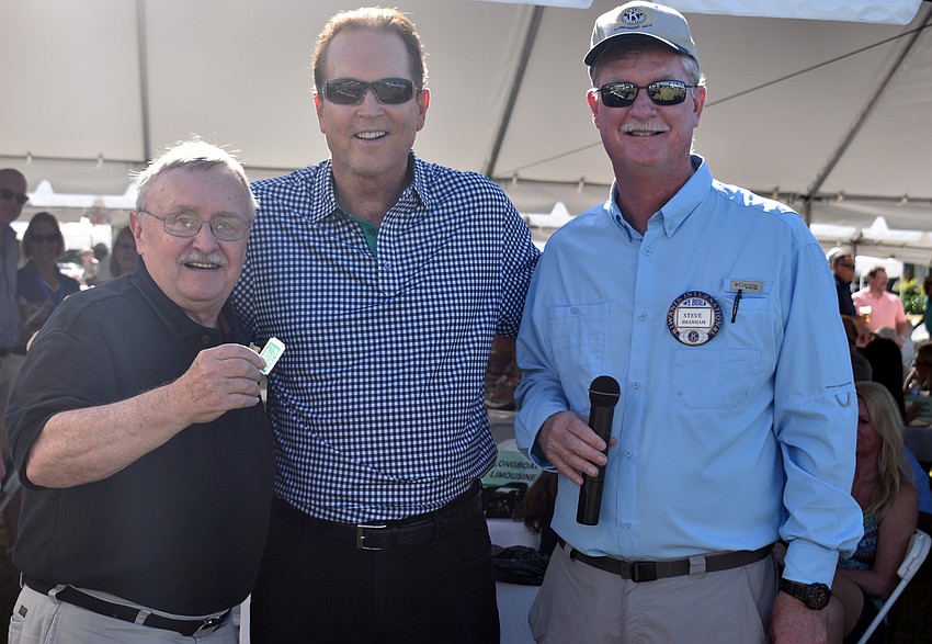 Bill Collins, winner of the 50/50 raffle, Congressman Vern Buchanan and Kiwanis Club President Steve Branham