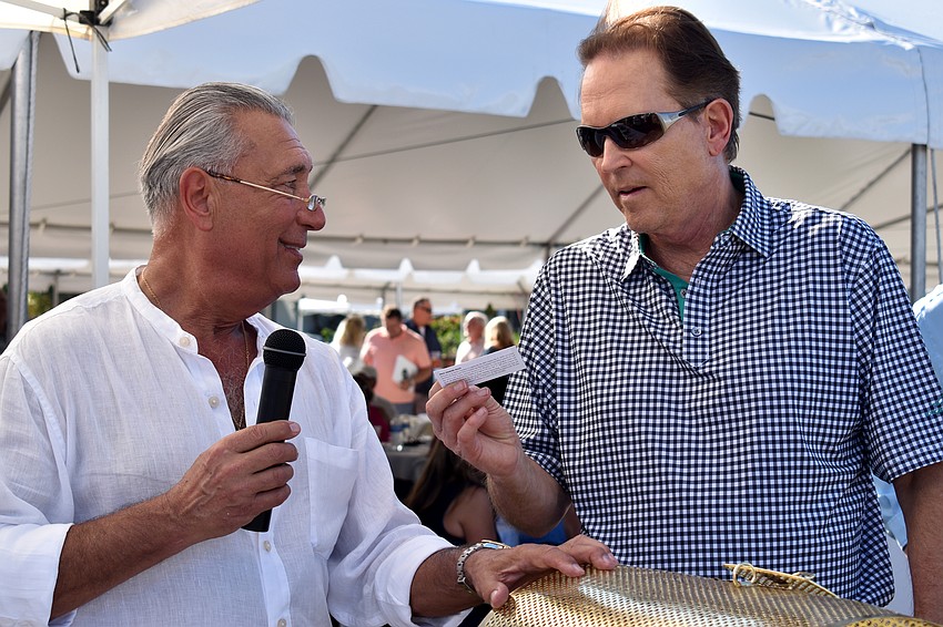 Andrew Vac and Congressman Vern Buchanan pull raffle tickets during the lawn party.