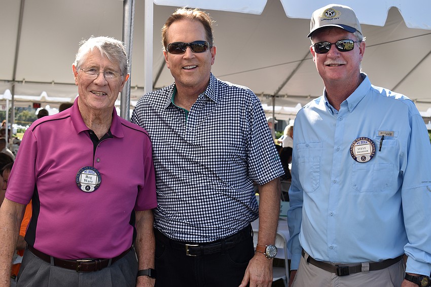 Reg Ware, with Congressman Vern Buchanan and Kiwanis Club President Steve Branham, accepts the raffle prize for the two-night stay at Zota Beach Resort.