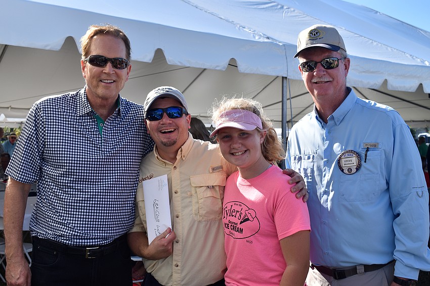 Congressman Vern Buchanan with Longboat Key Club golf package winners Rob and Ava Alderson and Kiwanis Club President Steve Branham