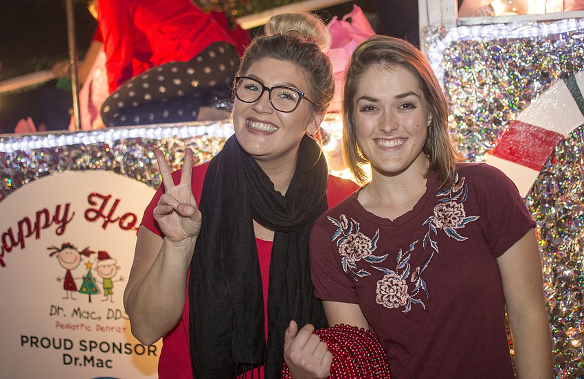 Amber Kennedy and Audra Deehr pose in front of the Make-A-Wish float before the Sarasota Holiday Parade.