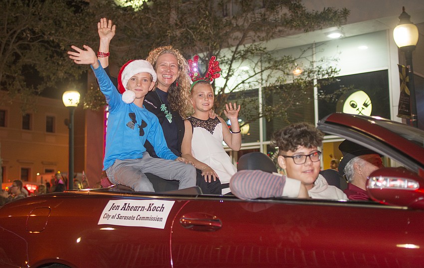 Bodhi Kirschner, City Commissioner Jennifer Ahearn-Koch and Selby Kirschner ride in the annual downtoan Sarasota holiday parade.