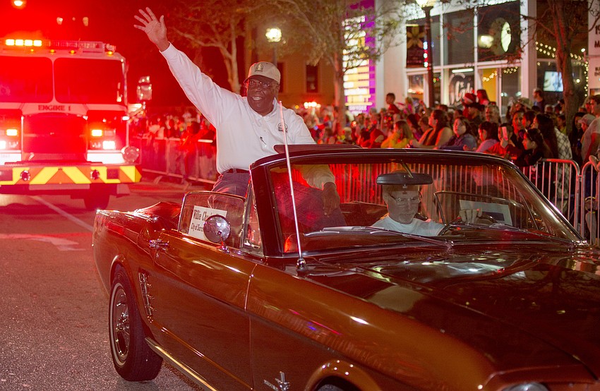 Sarasota City Commissioner Willie Charles Shaw waves at onlookers during the annual downtown Sarasota holiday parade.