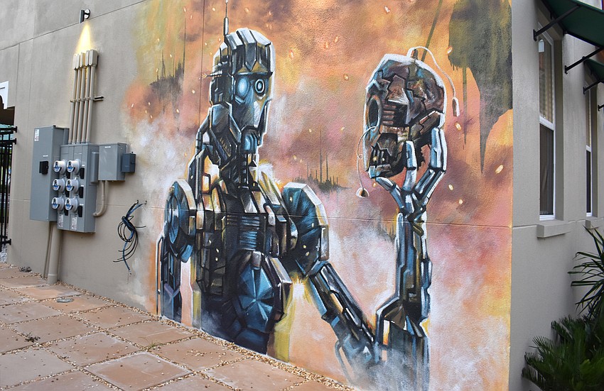 The murals on either side of the building are modern takes on “Hamlet.”