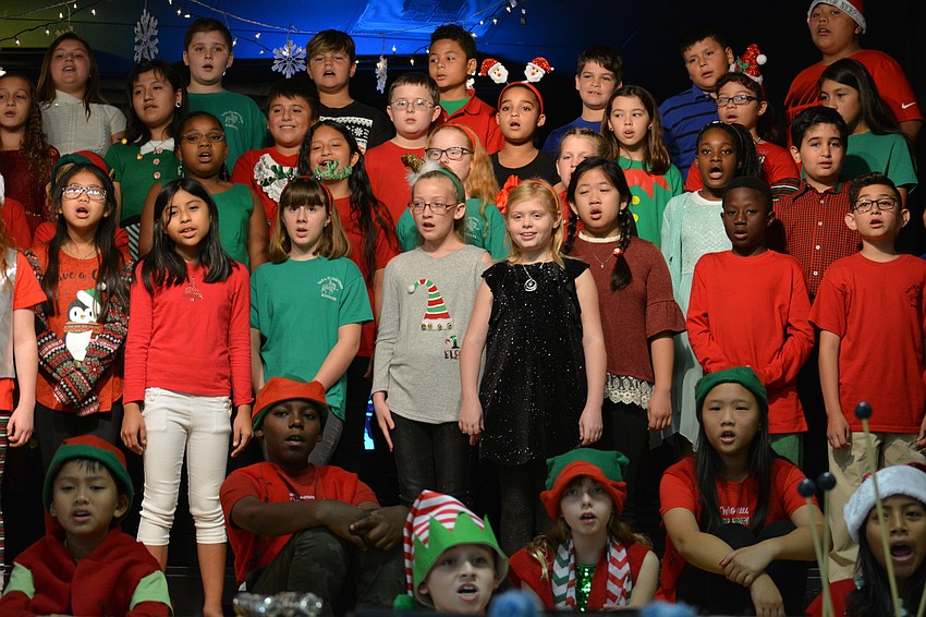Fifth-grade students share the holiday spirit through a series of songs, ending with a sing-a-long.
