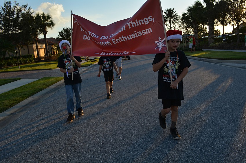 Patrick Cyganiewicz and Jaydon Carvin hold their banner proudly.