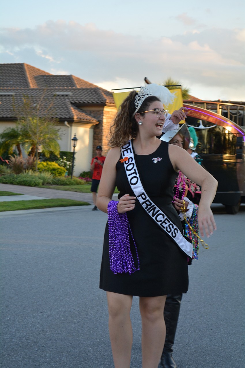 DeSoto Heritage Festival Princess Alyssa Kopinsky passes out beaded necklaces.