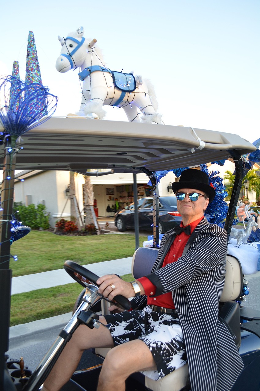 Wen Gill decorates his golf cart in blue and white.