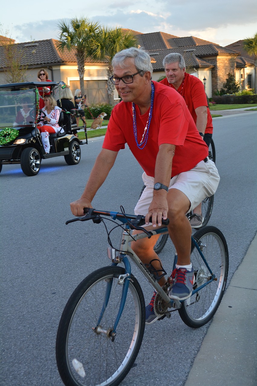 Larry Deanglis rides with a group of bicyclists.