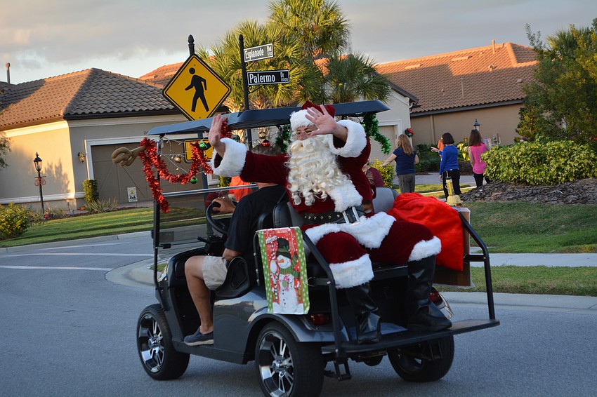 Mark Prucnell, as Santa, is on the last golf cart.