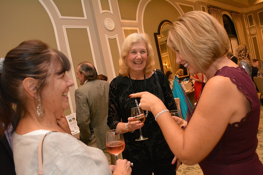 Patty Gieringer, Sue Spadaccia and Candi Russell converse during happy hour.