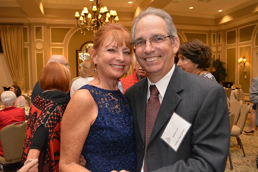 Helen and Robert Low enjoy a slow dance. Helen Low chaired the silent auction for the event.