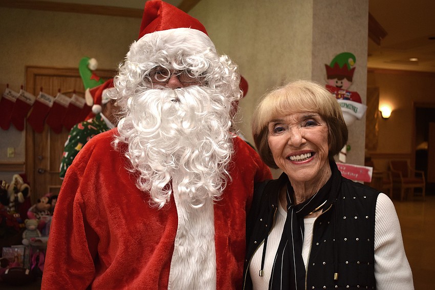 Doris Kaplan poses with Santa Claus.