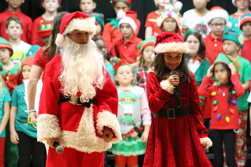 Willis Elementary School third-graders Peyton Gray and Juliana Armstron play their roles as Santa Claus and Mrs. Claus in the holiday show.