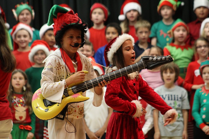Willis Elementary School third-graders Adrianna Galliano and Juliana Armstron dance side-by-side as Elfis and Mrs. Claus.