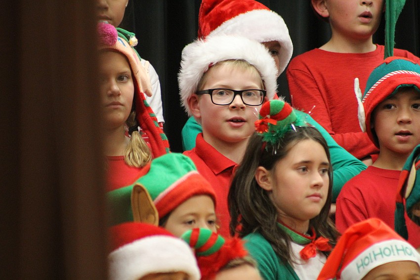 Willis Elementary School third-grader Kayden West sings along with the other elves during the third grade holiday extravaganza.