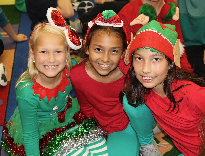 Willis Elementary School third-graders Natalie Franz, Samantha Miller and Malika Tokhtabayeva dress the part for the holiday show.