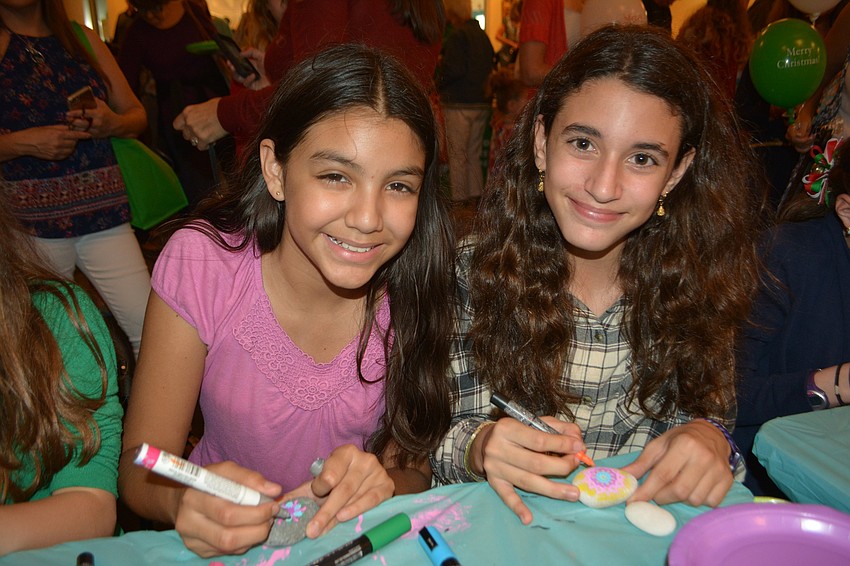 Sarasota's Carla Puentes, 12, and Lakewood Ranch's Manuela Jimenez, 12, color Kindness Project rocks.