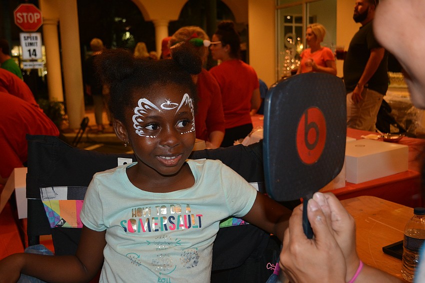 Skylar Ngwa of Lakewood Ranch checks out her face painting during Holidays Around the Ranch.