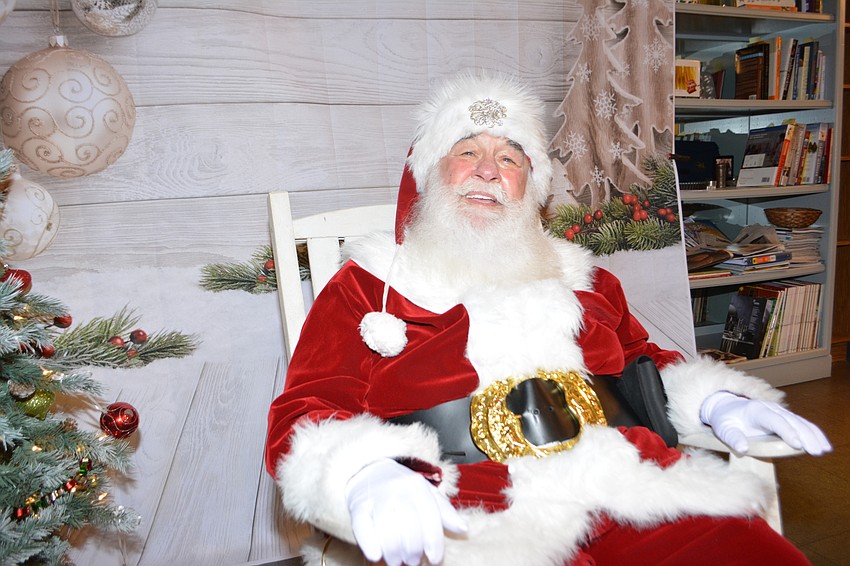 The potential for rain forced Santa indoors at the Culinary Innovation Lab at USF, but he greeted hundreds of children.