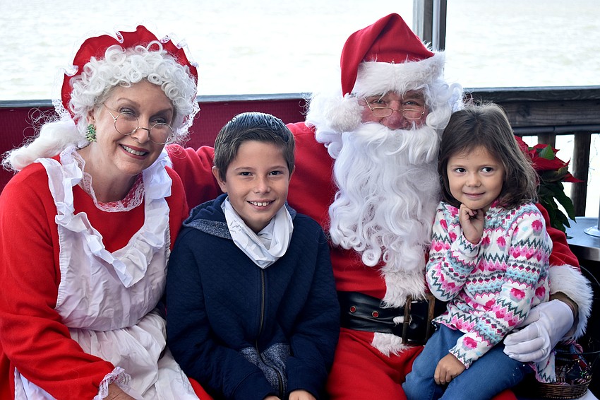 Alex and Sam Carmona visit with Santa and Mrs. Claus.