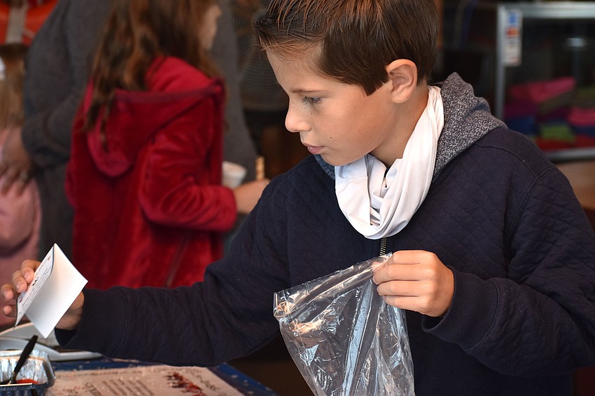 Alex Carmona makes a bag of reindeer food.