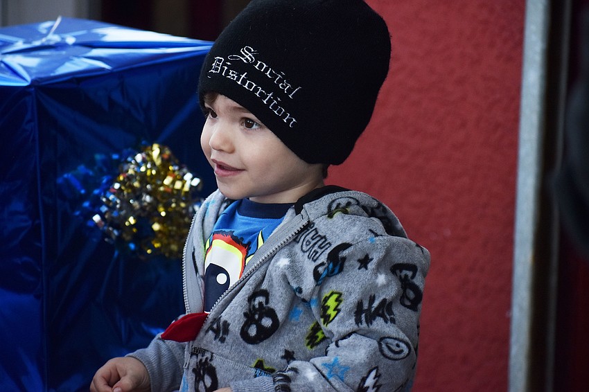Michael Scott waits his turn for a photo with Santa and Mrs. Claus.