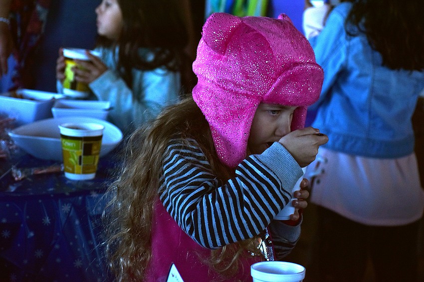Madison Fleahman sips on the hot chocolate she made at the hot chocolate bar.