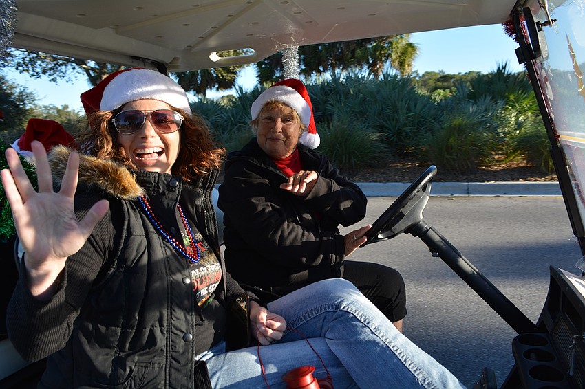 Keri Porter rides the parade on golf cart with her Lee Elzey.