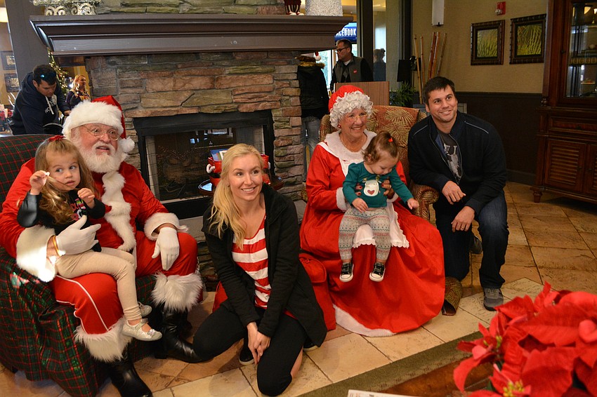Noel, Kim, Meadow and Wes Nordine pose with Santa and Mrs. Claus (Ron Lee and Carole Bakalar).