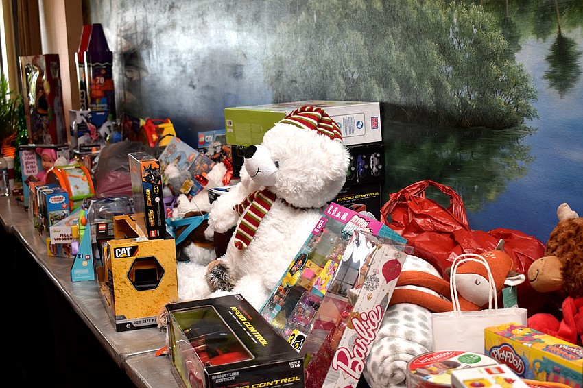 Golfers brought a toy to be donated to a local charity.