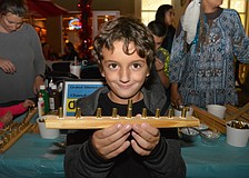 Lakewood Ranch&#39;s Alan Lopez Markov, 5, makes a menorah out of wood and bullet shell casings.
