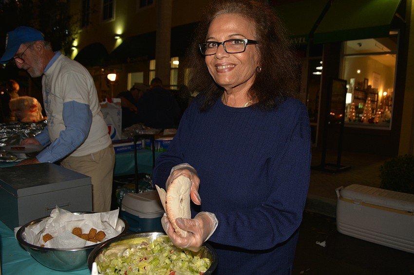 Volunteer Yardena Cohen serves up falafels to the crowd.